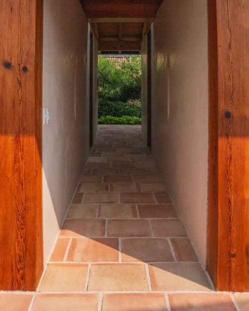 Wooden-door hallway at La Hacienda Tepoztlan leading to lush garden views in Tepoztlán