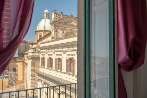 View from Orchidea room balcony at I colori della Sicilia in Caltagirone, Sicily showing golden dome church and historic