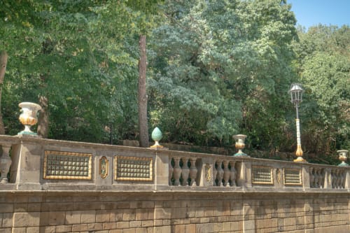 Ornate stone balustrade with decorative urns overlooks lush greenery at I colori della Sicilia in Caltagirone