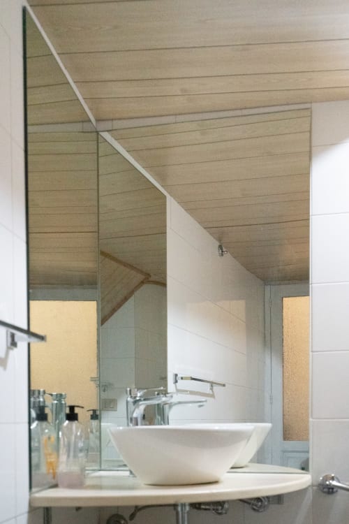 Modern bathroom at I colori della Sicilia in Caltagirone with vessel sink and curved mirror
