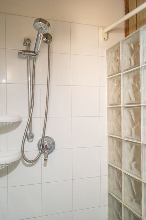 Modern shower with rainfall showerhead and handheld spray in Il sogno apartment at I colori della Sicilia boutique hotel,