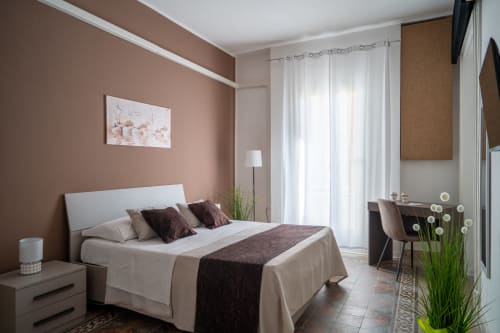 Diamante room at I colori della Sicilia in Caltagirone with queen bed, terracotta walls, city view balcony