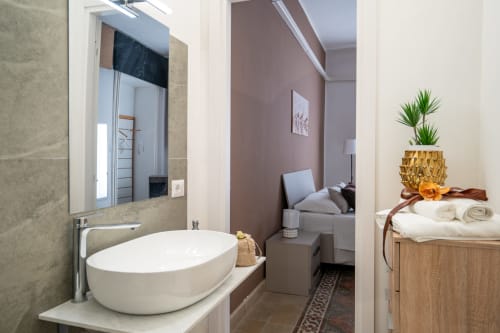 Modern bathroom in Diamante room at I Colori della Sicilia BnB, Caltagirone, with vessel sink, mirror, and bedroom view