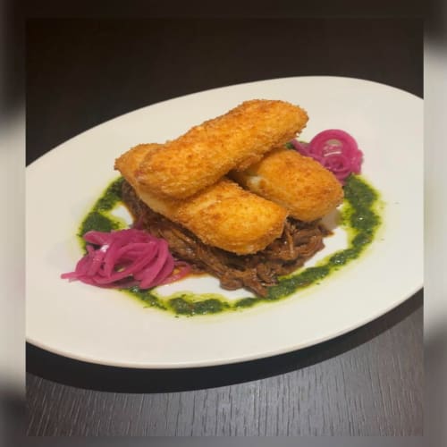 Gourmet plated dish with crispy croquettes, shredded meat, pickled onion, and green herb sauce at Sliabh Beagh Hotel,