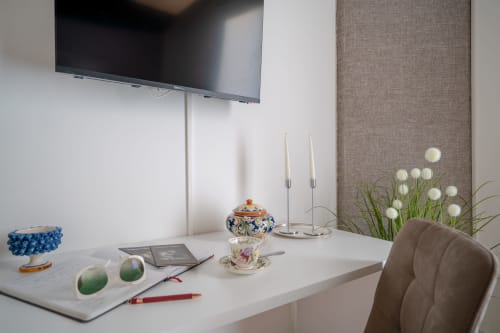 Modern desk in Perla room at I colori della Sicilia B&B, Caltagirone with desk accessories, decorative objects, and