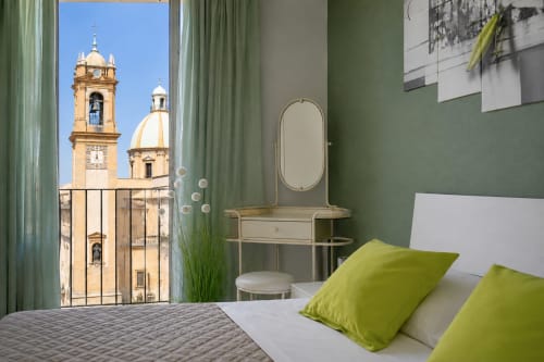 Camera moderna con dettagli verde lime con vista sulla cattedrale storica di Caltagirone, boutique hotel I colori della Sicilia
