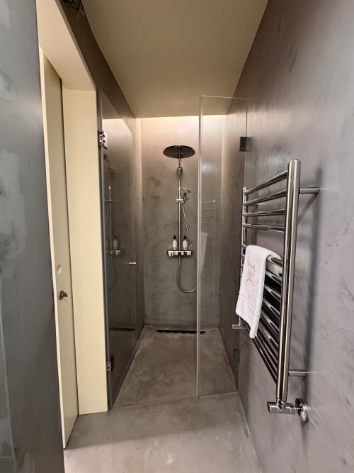 Modern shower enclosure with rainfall showerhead in Celeiro villa at Quinta Das Pirâmides, Vila Nova de Famalicão