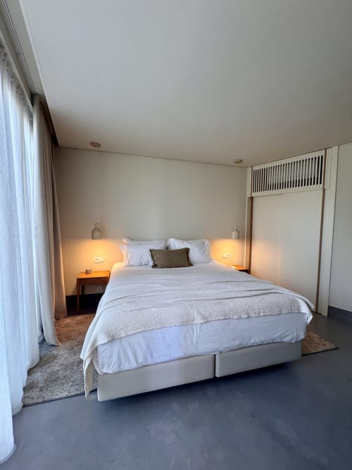 Celeiro villa bedroom at Quinta Das Pirâmides with queen bed, pendant lights, mountain views, and modern amenities in Vila