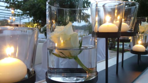 Ambiance élégante en soirée à Clos Bb à Saint-Cyr sur Mer avec bougies flottantes et roses blanches en vases de verre