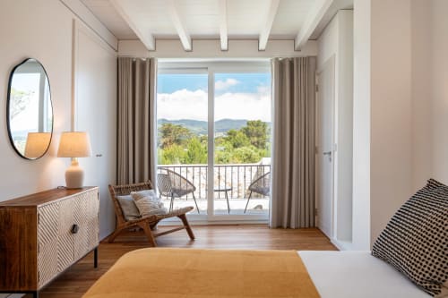 Modern villa bedroom with mountain view, wooden furnishings, balcony access at Sea'Ya Villas