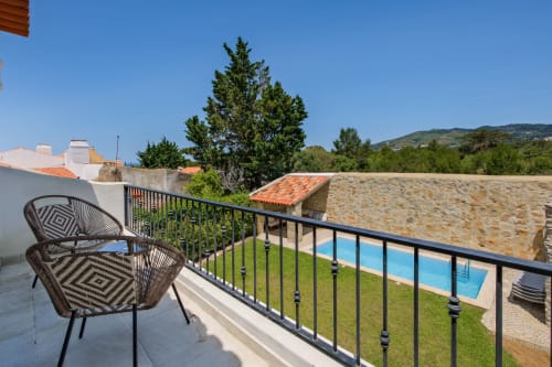 Balcony with seating overlooking private pool and mountain view at Sea'Ya Villa Juso, Aldeia de Juso Portugal