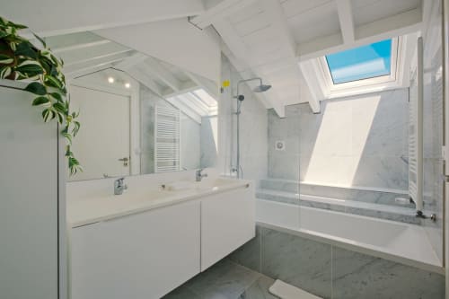 Modern bathroom at Sea'Ya Villa Juso with marble shower, double vanity, skylights, and mountain views in Aldeia de Juso