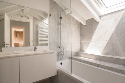 Luxurious bathroom at Sea'Ya Villa Juso with marble shower, white vanity, skylight, and modern fixtures in Aldeia de Juso