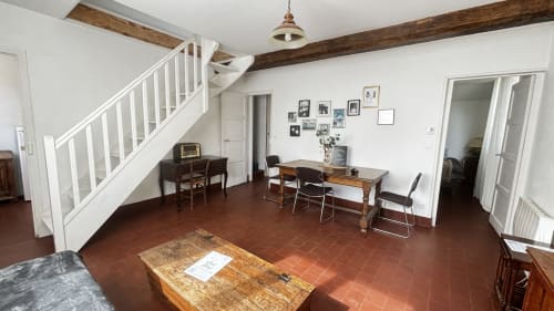 Le Chambre du Fournil at Le Gite De Saint Phal: spacious room with wooden beams, terracotta floor, dining table, and