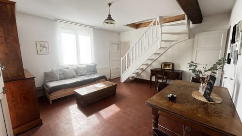 Le Chambre du Fournil at Le Gite De Saint Phal, rustic room with wooden furniture, staircase, and terracotta floors