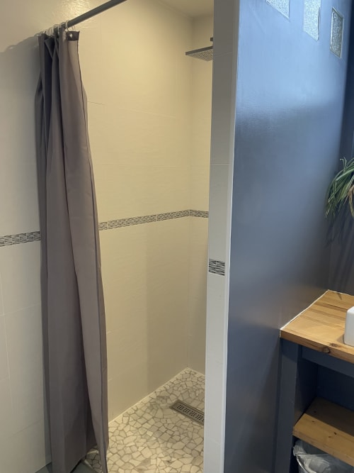 Modern shower stall with gray curtain at Au Bois Dormant BnB, Hesdin-la-Forêt