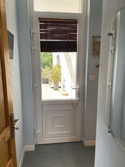 White door with blinds opening to patio at Au Bois Dormant B&B, Hesdin-la-Forêt