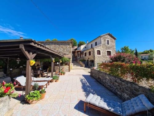 Stone gîte with terrace, pool, and mountain views in Gagnières, South of France