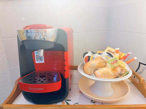 Bosch Tassimo coffee maker and pastry display at Chez Mary Studios Gannat apartment in Les 70'S room