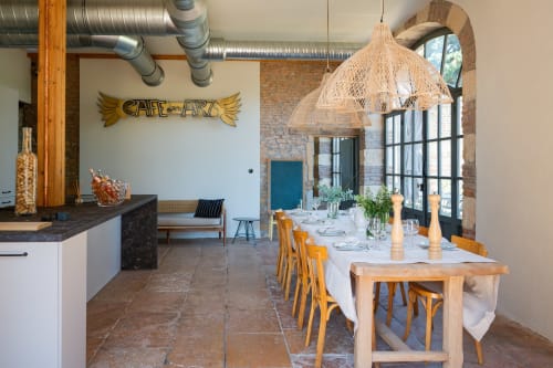Elegant dining room at La Maison & l'Orangerie BnB in Saint-Jean-des-Vignes with wooden table, yellow chairs, and woven