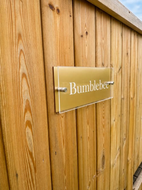 Bumblebee Pod sign on wooden door at Acorns Luxury Glamping in Holywell, GB