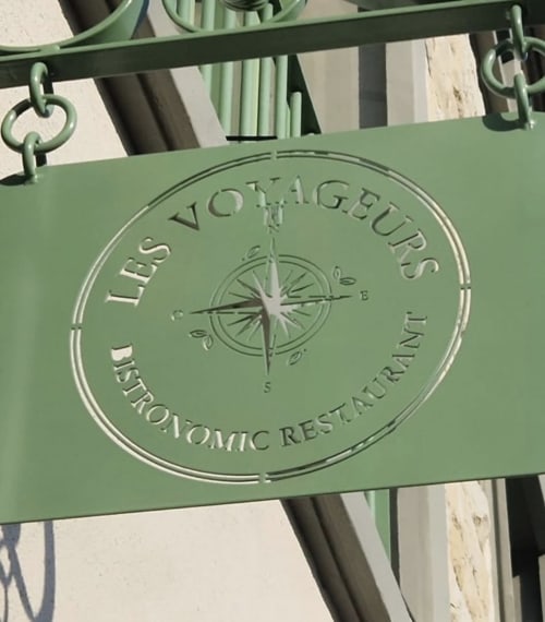Panneau vert avec rose des vents de l'hôtel Les séjours Ardennais à Renwez, France