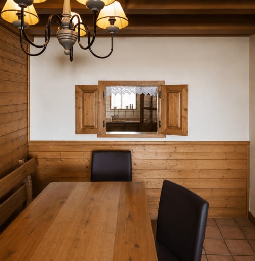 Rustic wooden dining room with mountain view window at Le Chalet des Cimes, Belle Plagne