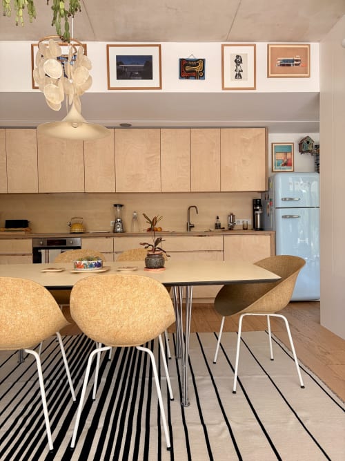 Modern villa kitchen at Maison Jalon, Aix-en-Provence with dining area, cork chairs, and retro-style blue refrigerator