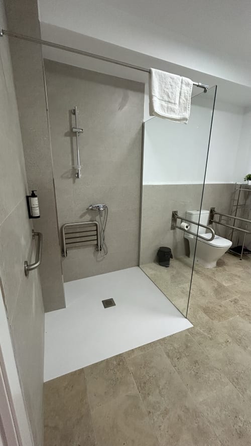 Modern bathroom with walk-in shower, glass partition, and toilet at Alojamientos Estrella Baeza apartment in Baeza, Spain