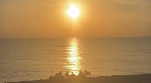 Coucher de soleil doré sur la mer à l'hôtel Hidden Bay, Cayeux-sur-Mer, silhouettes sur la plage