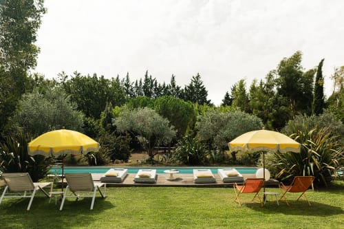 Villa Maison Jalon à Aix-en-Provence : piscine ensoleillée avec parasols jaunes, transats et jardins méditerranéens luxuriants
