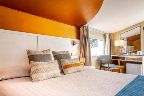 Habitación Doble Deluxe en Hotel La Muntanya, Llafranc, con vistas al mar, techo naranja y mobiliario moderno