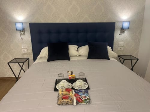 Camera Maritza Guest House Roma con testata nera, vassoio di benvenuto, applique doppie e vista sulla città