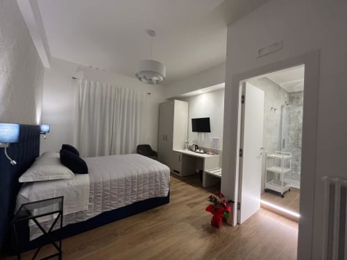 Camera moderna alla Maritza Guest House a Roma con letto queen, bagno privato, scrivania e vista sulla città