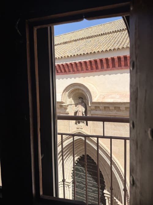 Vista desde el balcón de la Suite Julio César con vistas a los hitos arquitectónicos de Sevilla, tejas de terracota y arcos