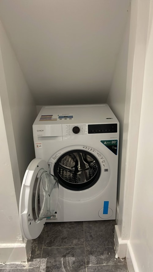 White Candy washing machine in alcove at La Rose Serenity Residence, London