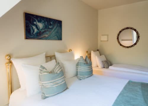 Helles Schlafzimmerzimmer im Domaine de Bize mit Einzelbetten, blau gestreiften Kissen und modernem Dekor in Mirepoix