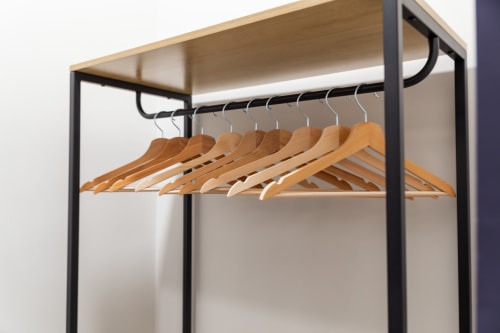 Modern clothing rack with wooden hangers at Darna Rooms luxury BnB in Naples