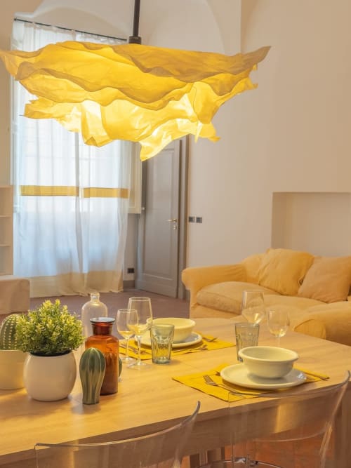 Elegant dining room at Living Palazzi Storici Bologna with yellow fabric pendant light and table setting