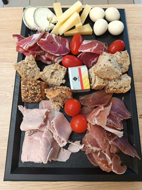Charcuterie board with cured meats, cheese, bread, tomatoes, and mozzarella at Le Clos du Thoronet hotel