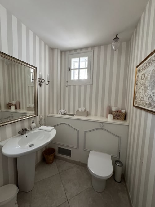 Elegantes Badezimmer im Domaine de Bize Mirepoix mit Streifentapete, Standwaschbecken und modernem WC