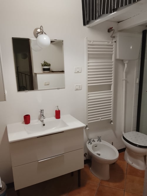 Moderno bagno bianco a Case Vacanze Borgo i Stritti, con lavabo, bidet, wc e scaldasalviette