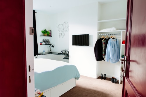Chambre moderne au B&B Place Jourdan Bruxelles avec espace de travail, penderie et portes bordeaux