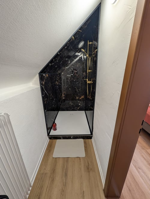 Black marble cosmetic organizer with gold accents in Bi d'Tante Irène cottage at Bi d'Grosseltere, Kirrwiller