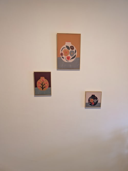 Three framed abstract artworks featuring decorative vessels on cream wall in Bi d'Tante Irène cottage, Kirrwiller