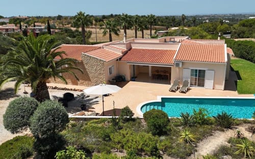 Villa Tulipa in Lagoa with private pool, terracotta roof, palm trees, and manicured garden