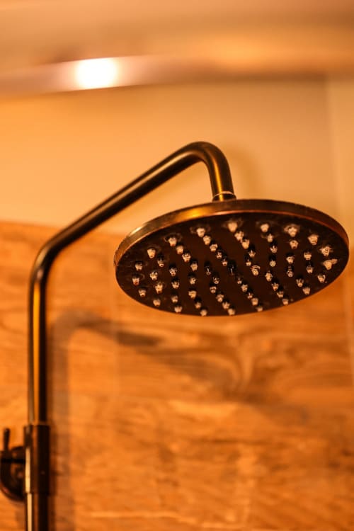 Black rainfall showerhead in Colorado Apartment at Greenvale Cabins, Newry