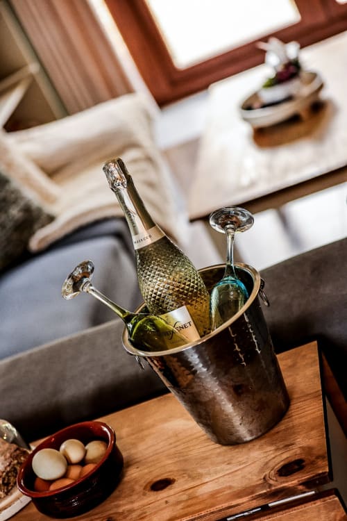 Champagne bottle and glasses in ice bucket at Greenvale Apartment, Newry - elegant dining setup with appetizers