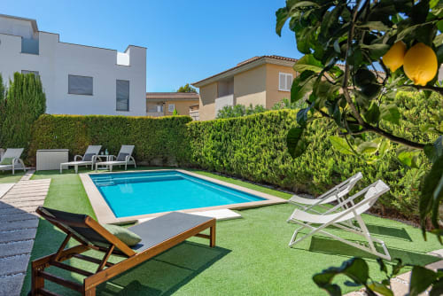 ACACIAS villa in Alcudia with private pool, lounge chairs, green hedges, lemon tree, and modern home backdrop