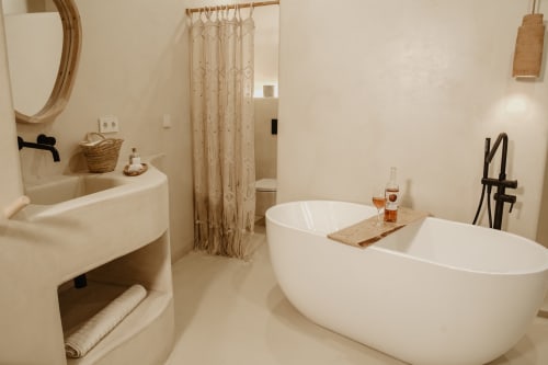 Salle de bain spa moderne à l'EntreArcos Eco-Boutique avec baignoire îlot blanche, vasque courbe et rideau de douche en macramé à Vejer
